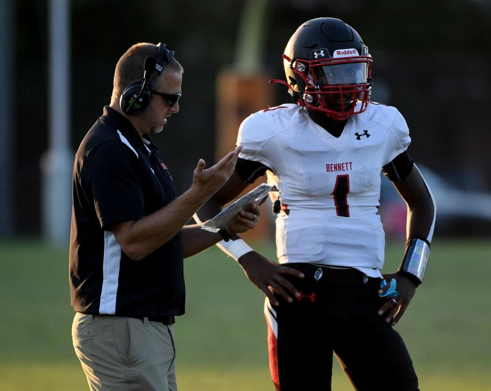 Bennett Head Football Coach Greg Lasinski gives the play to Zakai Smullen (1) in the game against Parkside Friday, Sept. 9, 2022, at the Wicomico County Stadium in Salisbury, Maryland.