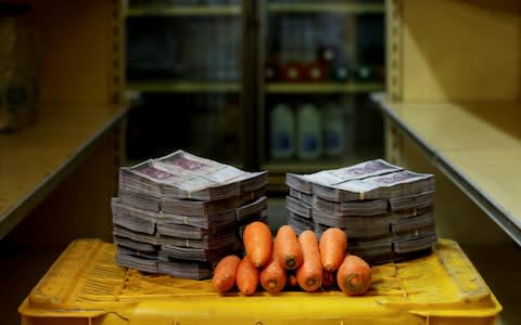 A kilogram of carrots is pictured next to 3,000,000 bolivars, its price and the equivalent of $0.46, at a mini-market in Caracas, Venezuela August 16, 2018. - Credit: Reuters