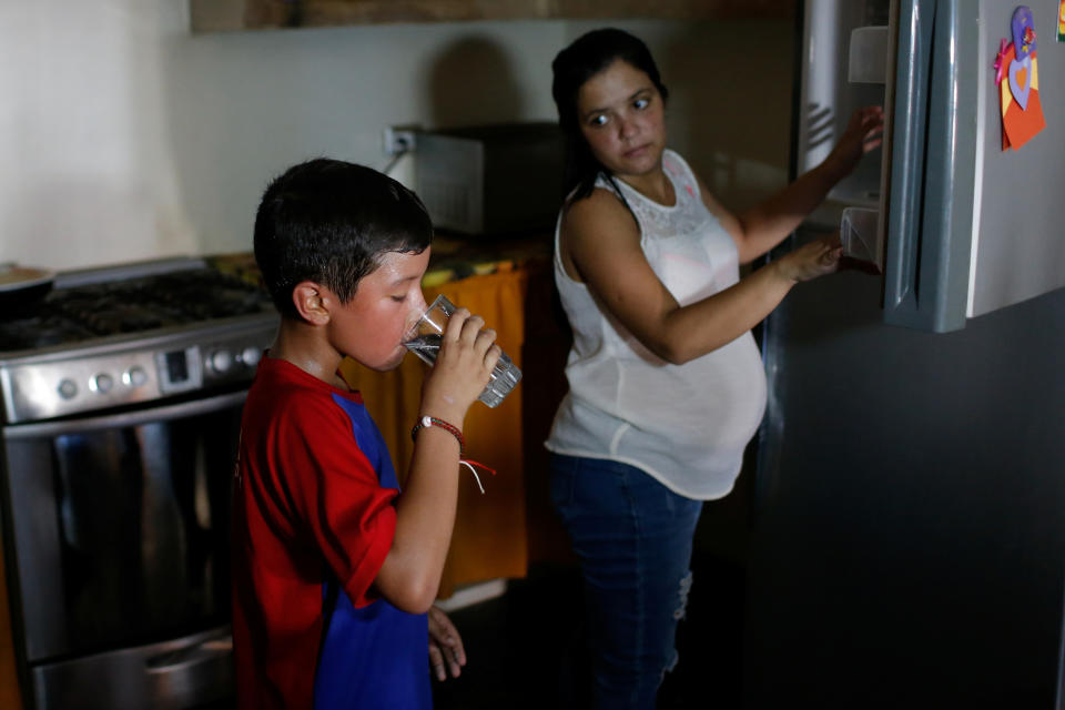 Baseball little league player Santiago Lopez, 10, drinks water after training at his house during an electricity cut in Maracaibo, Venezuela.  (Photo: Manaure Quintero/Reuters)