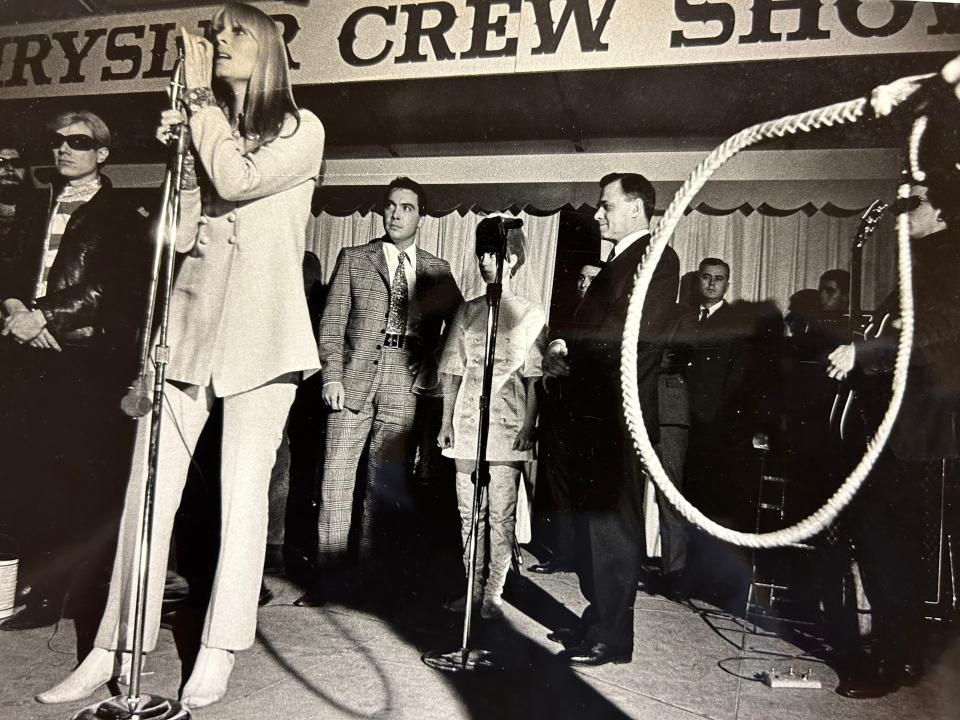 Nico performs. The Free Press said the Velvet Underground vocalist sounded like a woman singing a funeral dirge "while accompanied by an off-key air-raid siren." The bullwhip, right, was used by poet Gerard Malanga when he danced across the stage along with two high-powered flashlights. Listening are Mod Wedding impresario Andy Warhol, left, the bridal couple and judge.