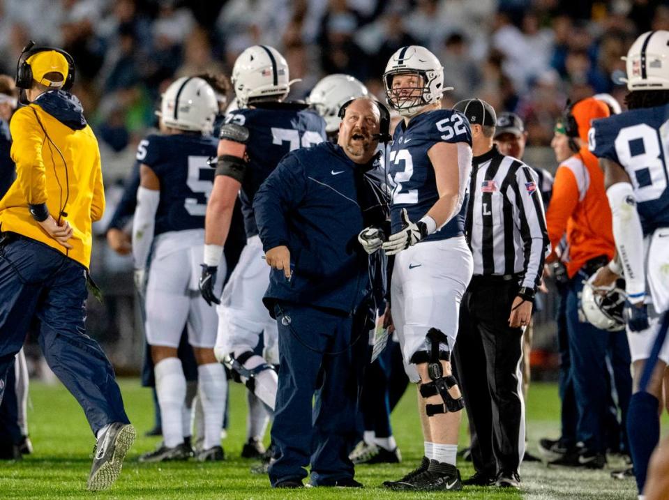 Penn State special teams coordinator Stacy Collins and defensive tackle Jordan van den Berg watch a replay during the game on Saturday, Nov. 12, 2022.