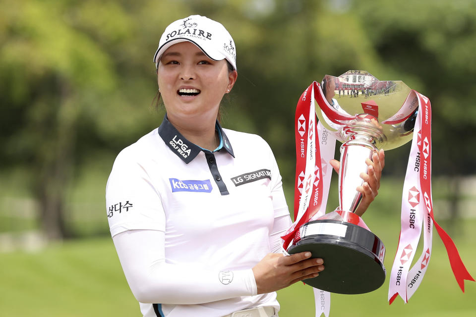 Jin Young Ko of South Korea holds the championship trophy after winning the Women's World Championship golf tournament at Sentosa Golf Club in Singapore, Sunday, March 6, 2022. (AP Photo/Paul Miller)