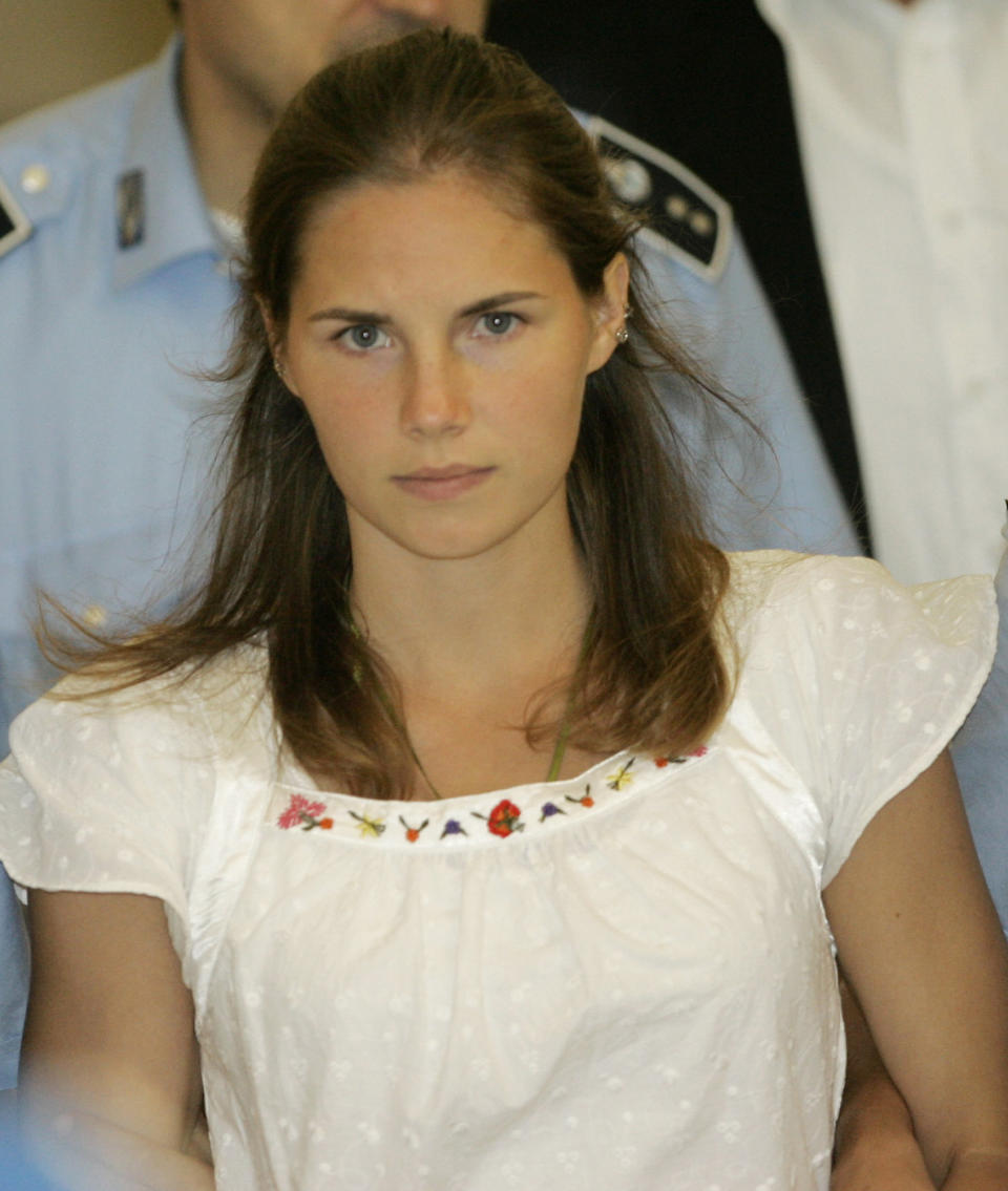 FILE - In this Tuesday Sept. 16, 2008 file photo, then murder suspect Amanda Knox is escorted by Italian penitentiary police officers from Perugia's court after a hearing, central Italy. Few international criminal cases have cleaved along national biases as that of American student Amanda Knox, awaiting half world away her third Italian court verdict in the 2007 slaying of her British roommate, 21-year-old Meredith Kercher. Whatever is decided this week, the protracted legal battle that has grabbed global headlines and polarized trial-watchers in three nations probably won't end in Florence. With the first two trials producing flip-flop guilty-then-innocent verdicts against Knox and her former Italian boyfriend, Raffaele Sollecito, the case has produced harshly clashing versions of events. A Florence appeals panel designated by Italy's supreme court to address errors in the appeals acquittal is set to deliberate Thursday, Jan. 30, 2014, with a verdict expected later in the day .(AP Photo/Antonio Calanni, File)