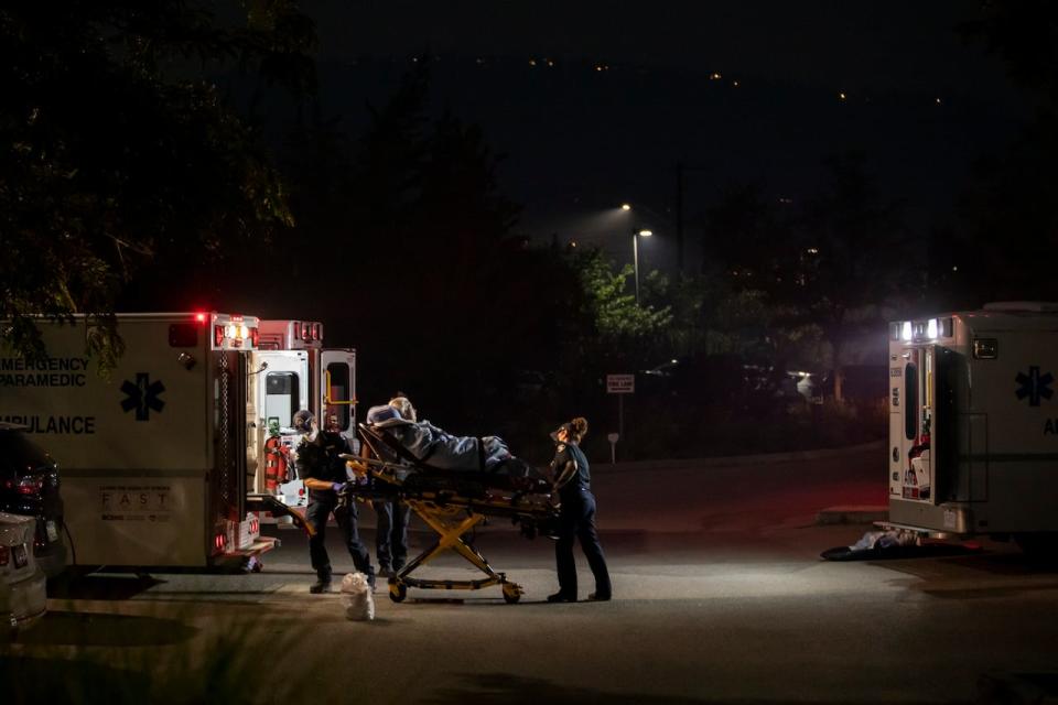 Paramedics evacuate patients out of the Brandt's Creek Retirement Housing seniors home as the McDougall Creek wildfire approaches the city of Kelowna, British Columbia on Aug. 18, 2023. 