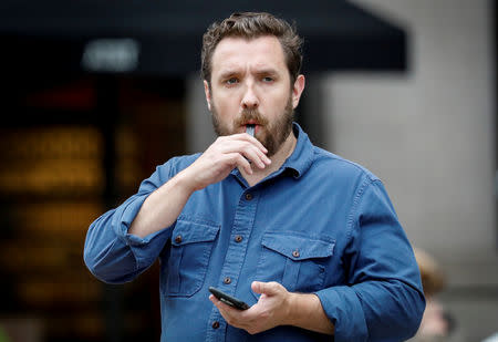 A man smokes a Juul e-cigarette in New York City, U.S., September 13, 2018. REUTERS/Brendan McDermid