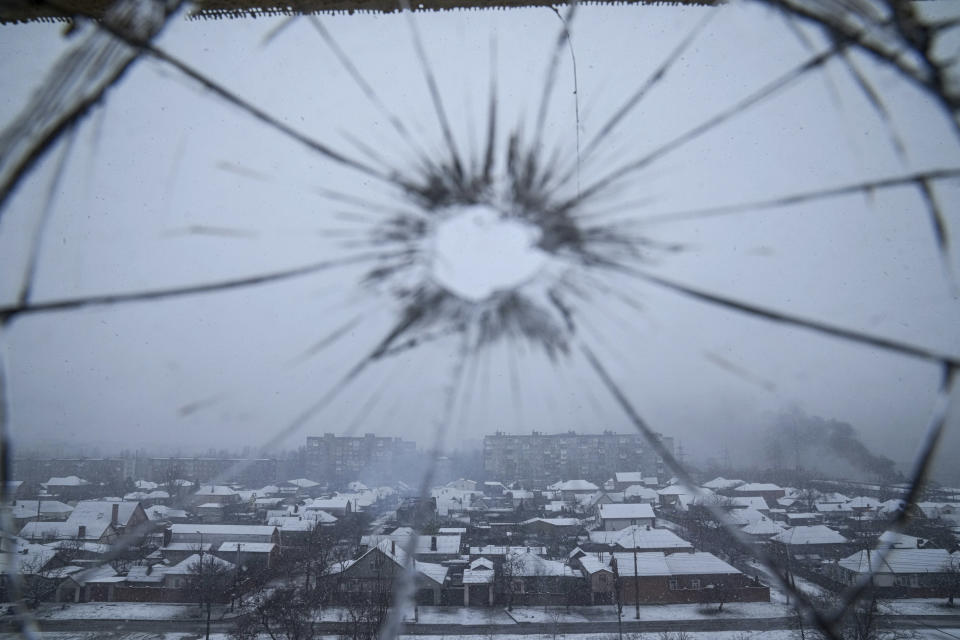 FILE - A hospital window is cracked from shelling in Mariupol, Ukraine, Thursday, March 3, 2022. Russia began evacuating its embassy in Kyiv, and Ukraine urged its citizens to leave Russia. Unbroken by a Russian blockade and relentless bombardment, the key port of Mariupol is still holding out, a symbol of staunch Ukrainian resistance that has thwarted the Kremlin's invasion plans. (AP Photo/Evgeniy Maloletka)