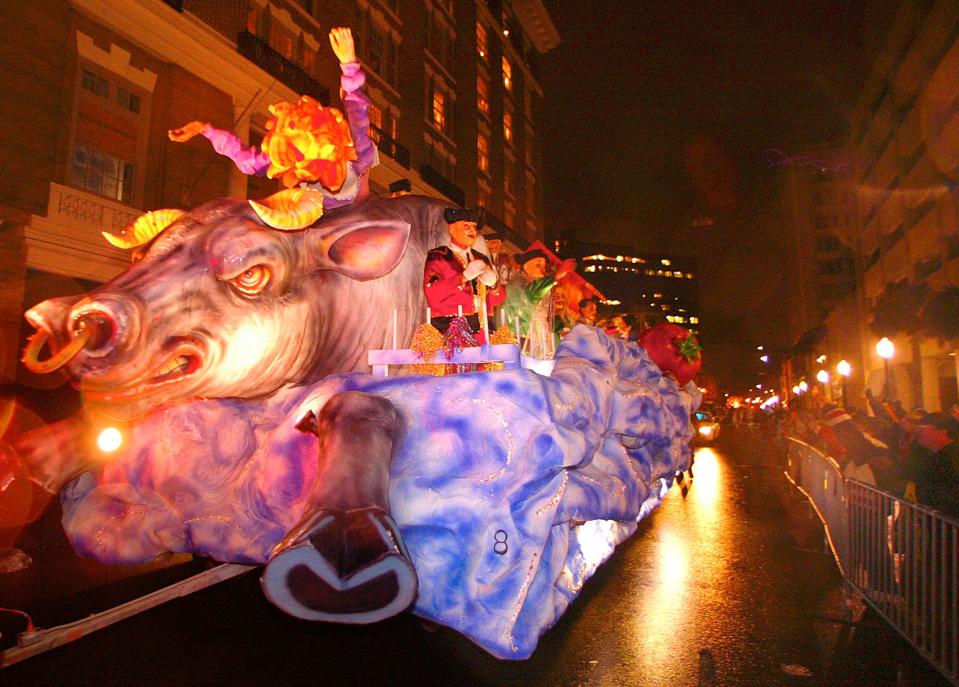 An Order of the Inca float entitled "I Want To Run With The Bulls" rolls down Royal Street as riders throw beads and moonpies to crowds gathered along the streets of Mobile, Ala., Friday, Jan. 28, 2005. The pre-Lenten blowout continues along the Gulf Coast culminating in Fat Tuesday celebrations Feb. 8th. (AP Photo/Mobile Register, G.M. Andrews) ORG XMIT: ALMOP306