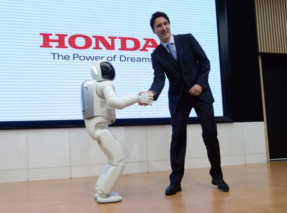 Prime Minister Justin Trudeau meets Honda Robot Asimo as he visits Honda Motor Co. headquaters in Tokyo, Japan on Tuesday, May 24, 2016. THE CANADIAN PRESS/Sean Kilpatrick