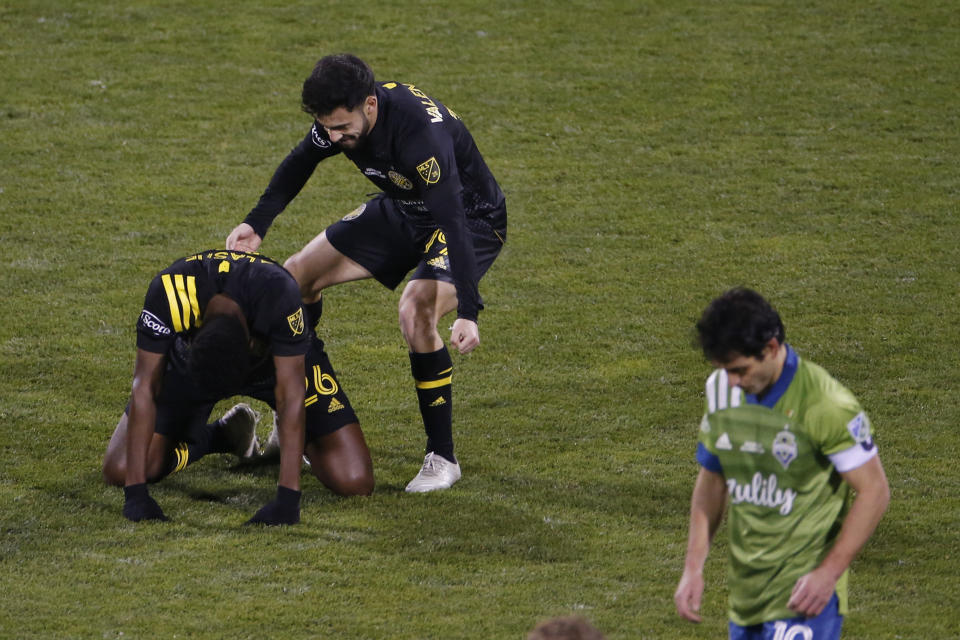 Columbus Crew players celebrate after defeating the Seattle Sounders 3-0 in the MLS Cup championship game Saturday, Dec. 12, 2020, in Columbus, Ohio. (AP Photo/Jay LaPrete)