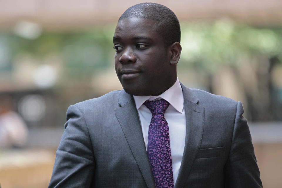 FILE This Tuesday, Sept. 18, 2012 file photo shows former trader Kweku Adoboli leaving Southwark Crown Court in London for a lunch break from his trial at the court. A rogue trader who lost $2.2 billion in bad deals at Swiss bank UBS was convicted of fraud on Tuesday, Nov. 20, 2012. Ghanaian-born Kweku Adoboli, 32, exceeded his trading limits and failed to hedge trades, allegedly faking records to cover his tracks at the bank's London office. At one point, Adoboli risked running losses of up to $12 billion. The fraud conviction carries a maximum jail term of 10 years. (AP Photo/Sang Tan)