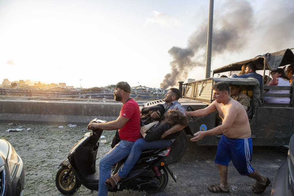 Wounded people evacuate after a massive explosion in Beirut. | Hassan Ammar—AP