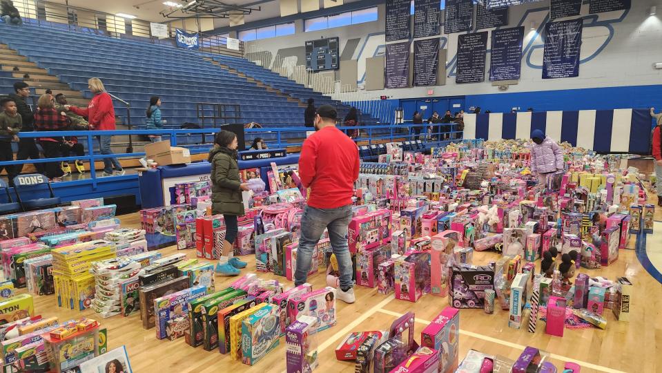 A child looks over the floor full of toys Saturday at the 10th annual Northside Toy Drive held at the Palo Duro High School Gym in Amarillo.