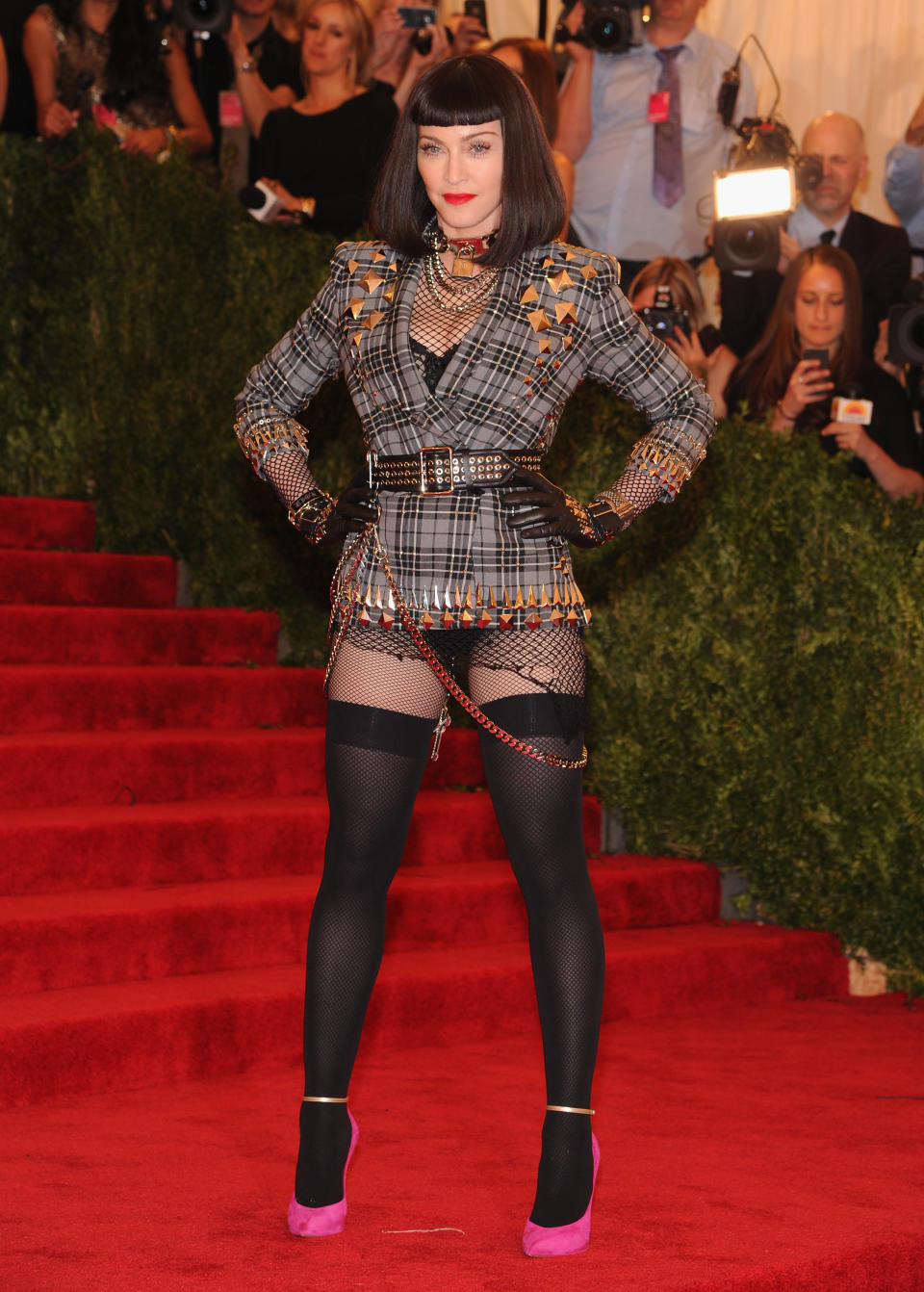 <p>Madonna matched neon with tartan in 2013 to make for the ultimate punk ensemble. Photo: Getty Images </p>