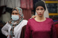 A Muslim vendor wearing protective mask waiting for customers at a Ramadan bazaar, amid the outbreak of the coronavirus disease (COVID-19) in Kuala Lumpur, Malaysia, Monday, April 19, 2021. (AP Photo/Vincent Thian)