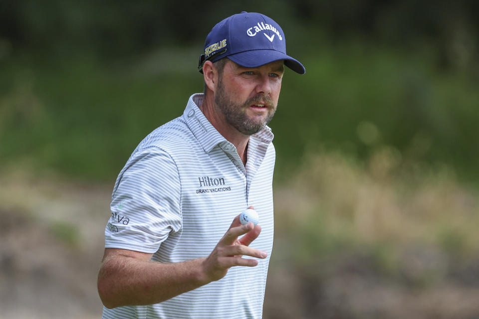 Australia's Marc Leishman acknowledges the crowd after putting on the 13th hole during the Australian Open golf championship at Victoria golf course in Melbourne, Australia, Thursday, Dec. 1, 2022. (AP Photo/Asanka Brendon Ratnayake)