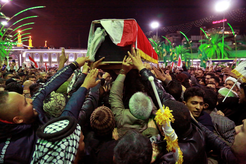 Mourners carry the coffins of Iran's top general Qassem Soleimani and Abu Mahdi al-Muhandis, deputy commander of Iran-backed militias in Iraq known as the Popular Mobilization Forces, during their funeral in Karbala, Iraq, Saturday, Jan. 4, 2020. Iran has vowed "harsh retaliation" for the U.S. airstrike near Baghdad's airport that killed Tehran's top general and the architect of its interventions across the Middle East, as tensions soared in the wake of the targeted killing. (AP Photo/Khalid Mohammed)