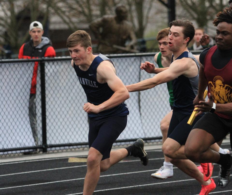 Granville's Connor Hare takes the baton from Spencer Beckett for the third leg of the 400 relay at the Granville Invitational on Friday.