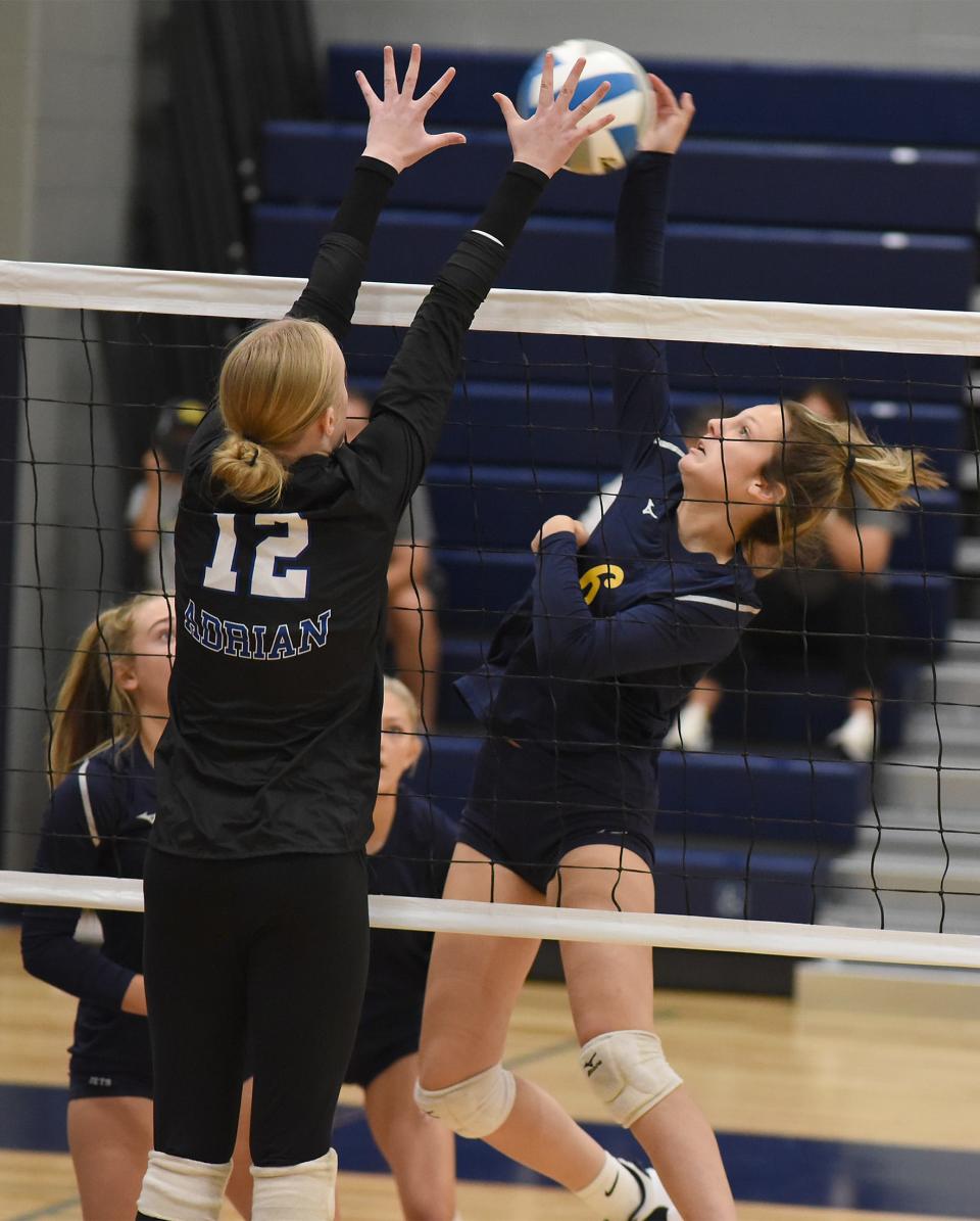 Jillian Baker of Airport attempts to spike past Allison Shaw of Adrian as Whiteford hosted their first volleyball tournament Wednesday, August 16, 2023 in their new facility. 