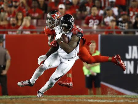 Nov 3, 2016; Tampa, FL, USA; Atlanta Falcons wide receiver Mohamed Sanu (12) runs with the ball as Tampa Bay Buccaneers free safety Bradley McDougald (30) defends during the second half at Raymond James Stadium. Atlanta Falcons defeated the Tampa Bay Buccaneers 43-28. Mandatory Credit: Kim Klement-USA TODAY Sports