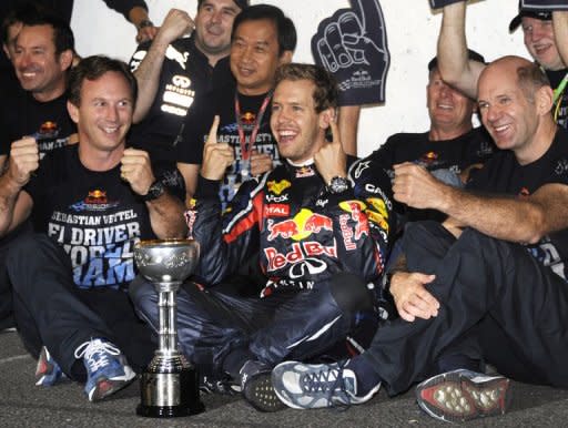 Red Bull driver Sebastian Vettel of Germany celebrates on his car