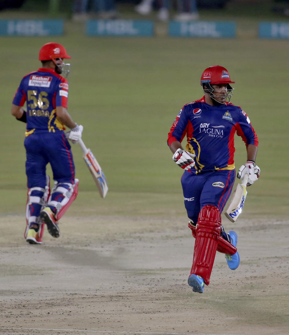 Karachi Kings' Sharjeel Khan, right, and Babar Azam run between the wickets during a Pakistan Super League T20 cricket match between Karachi Kings and Islamabad United at the National Stadium, in Karachi, Pakistan, Wednesday, Feb. 24, 2021. (AP Photo/Fareed Khan)