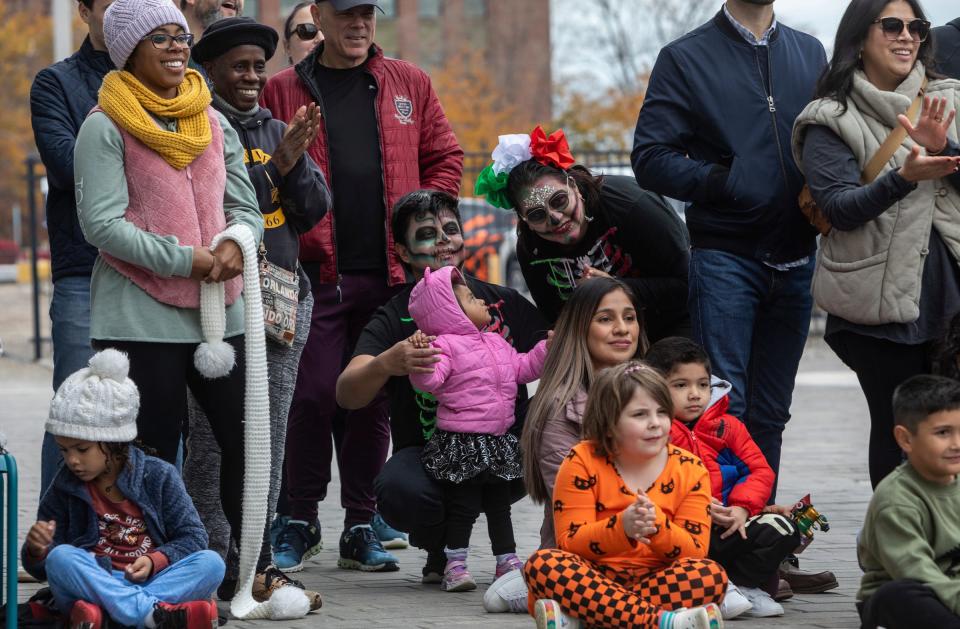 Dozens of people gather to celebrate a Dia de los Muertos event organized by the Detroit Riverfront Conservancy at the Robert C. Valade Park in Detroit on Saturday, Oct. 28, 2023.