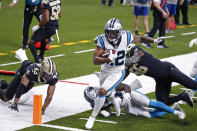 Carolina Panthers wide receiver D.J. Moore (12) crosses the goal line in front of New Orleans Saints outside linebacker Demario Davis (56) and free safety Marcus Williams (43) in the first half of an NFL football game in New Orleans, Sunday, Oct. 25, 2020. (AP Photo/Butch Dill)