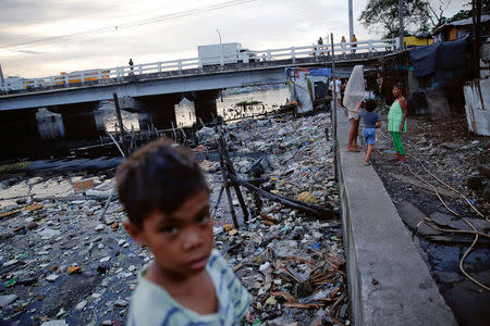 Local residents pass the time under C-3 bridge in North Bay Boulevard South (NBBS), a Navotas City district of slums and waterways with a high number of drug war deaths, in Manila, Philippines November 3, 2016. REUTERS/Damir Sagolj