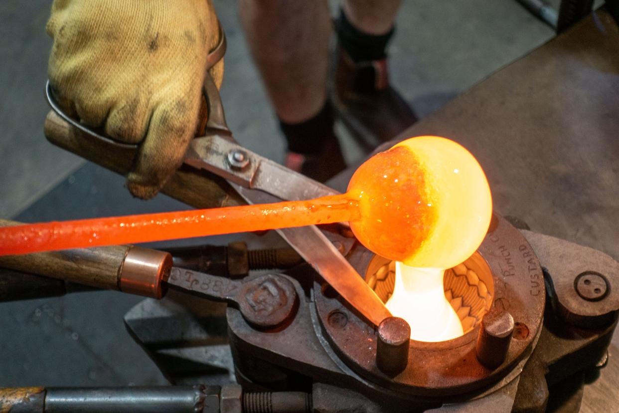 Pouring molten glass into the mold for the Jenny Lind custard bowl at AO Glass on Pine Street.
