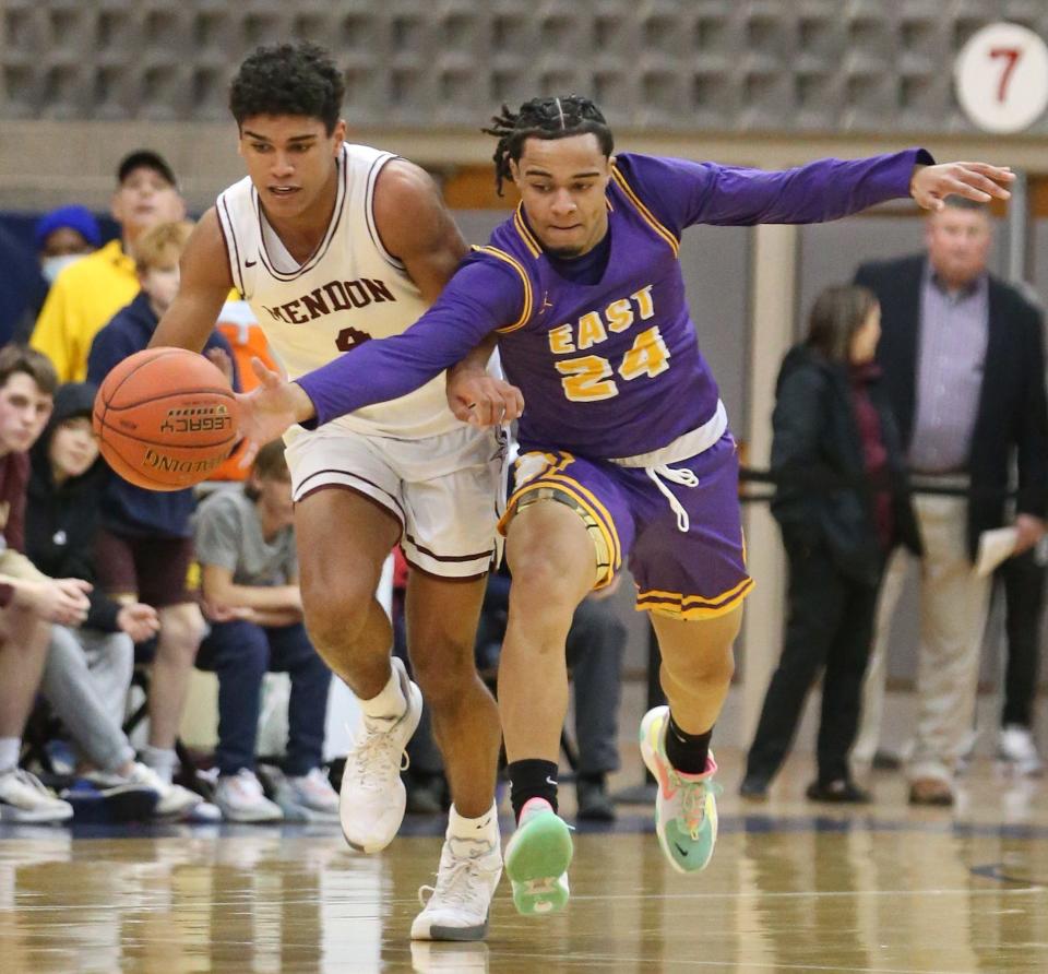 East's Jeramiah Handy (24), right, just misses a steal from behind on Pittsford Mendon's Jackson Green (4), left, during their Class A Regional Qualifier game at Gates Chili High School Wednesday, March 9, 2022. 