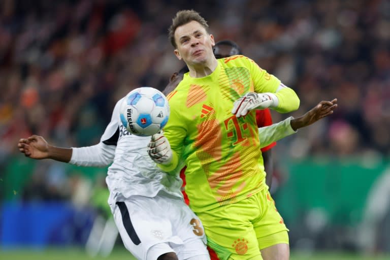 Manuel Neuer (front) fouls Bayer Leverkusen's Jeremie Frimpong, earning a red card and suffering a broke rib that will sideline him until next year (Michaela STACHE)