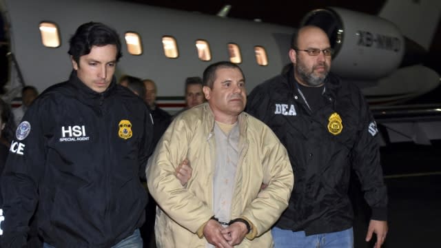 Authorities escort Joaquin "El Chapo" Guzman.