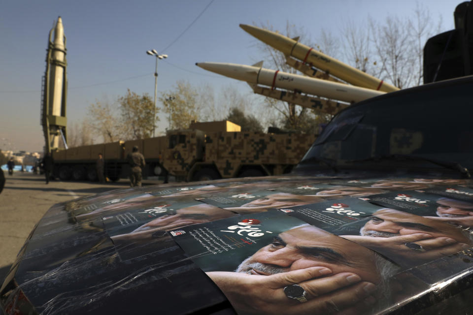 ADDS NAMES OF MISSILES - Posters of Iranian Gen. Qassem Soleimani, who was killed in Iraq in a U.S. drone attack in Jan. 3, 2020, are seen in front of Qiam, background left, Zolfaghar, top right, and Dezful missiles displayed in a missile capabilities exhibition by the paramilitary Revolutionary Guard a day prior to second anniversary of Iran's missile strike on U.S. bases in Iraq in retaliation for killing Gen. Soleimani, at Imam Khomeini grand mosque, in Tehran, Iran, Friday, Jan. 7, 2022. Iran put three ballistic missiles on display on Friday, as talks in Vienna aimed at reviving Tehran's nuclear deal with world powers flounder. (AP Photo/Vahid Salemi)