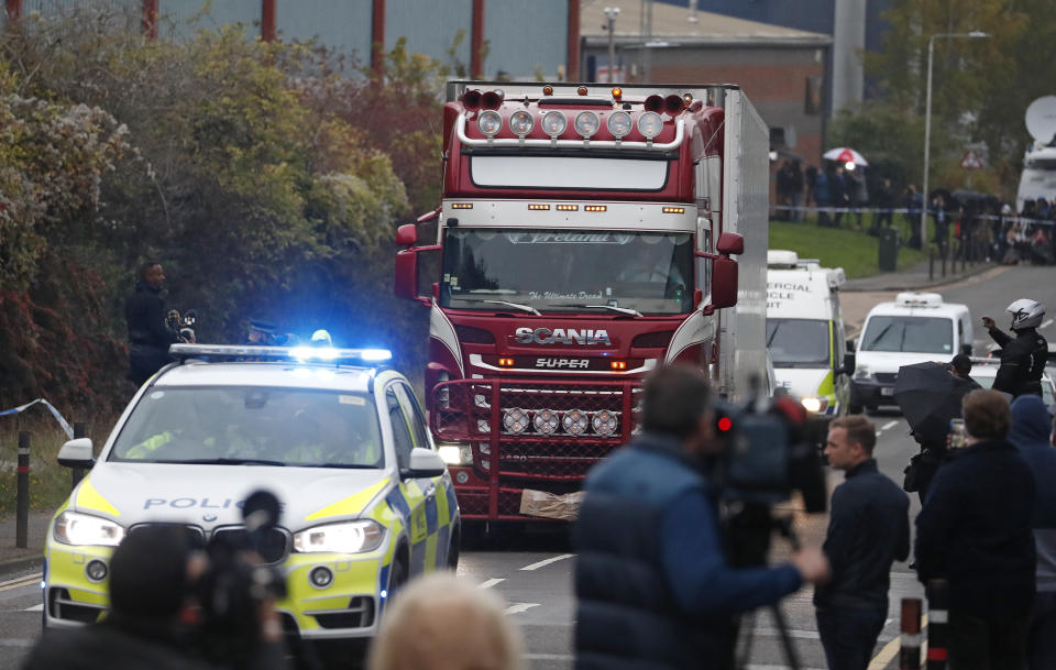 Police escort the truck, that was found to contain a large number of dead bodies, as they move it from an industrial estate in Thurrock, south England, Wednesday Oct. 23, 2019. Police in southeastern England said that 39 people were found dead Wednesday inside a truck container believed to have come from Bulgaria. (AP Photo/Alastair Grant)