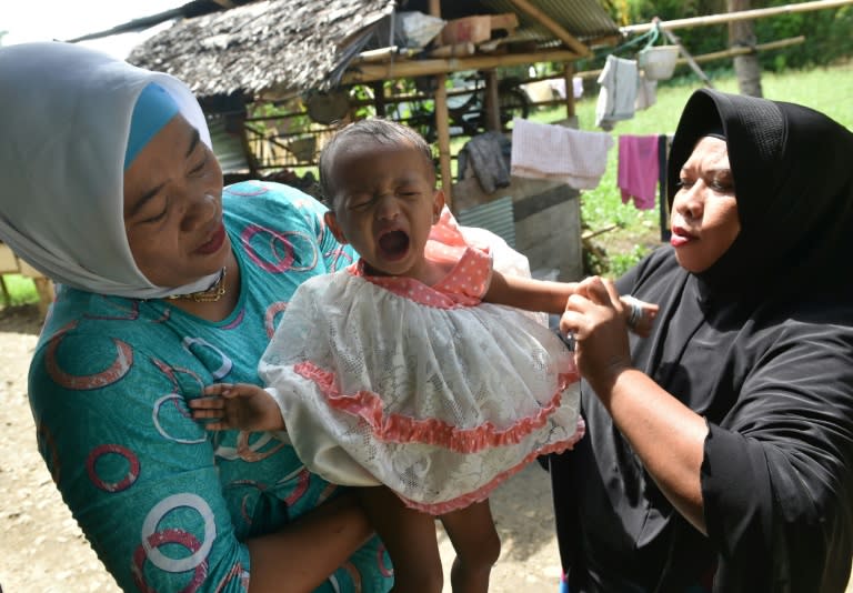 Toddler Salsa Djafar cries after her circumcision in Gorontalo, Indonesia