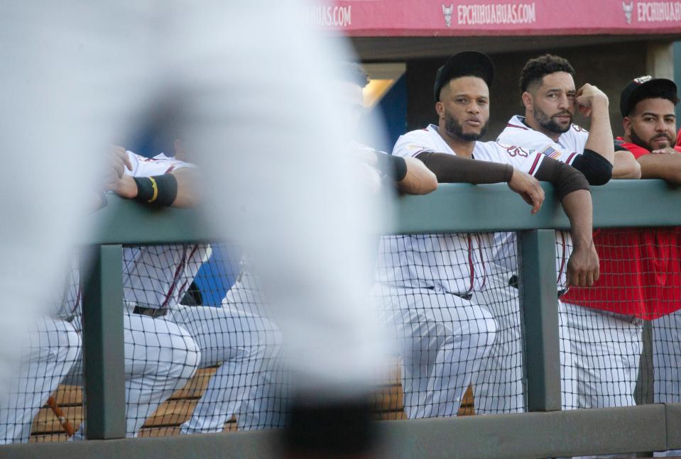 El Paso Chihuahuas Robinson Cano, left, watches the game against the Las Vegas Avaitors at Southwest University Park in El Paso Texas on June 14, 2022.