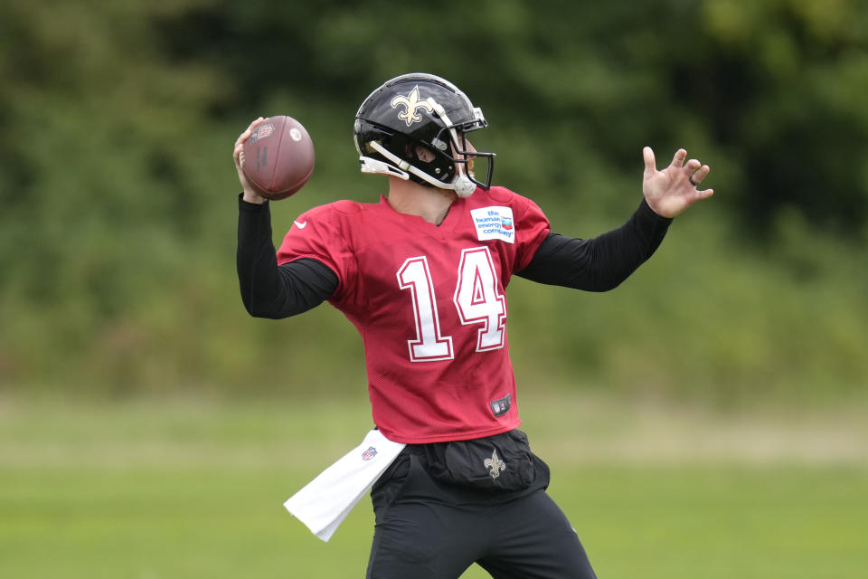 New Orleans Saints quarterback Andy Dalton throws the ball during an NFL practice session at the London Irish rugby team training ground in Sunbury-on-Thames near London, Wednesday, Sept. 28, 2022 ahead of the NFL game against Minnesota Vikings at the Tottenham Hotspur stadium on Sunday. (AP Photo/Kirsty Wigglesworth)