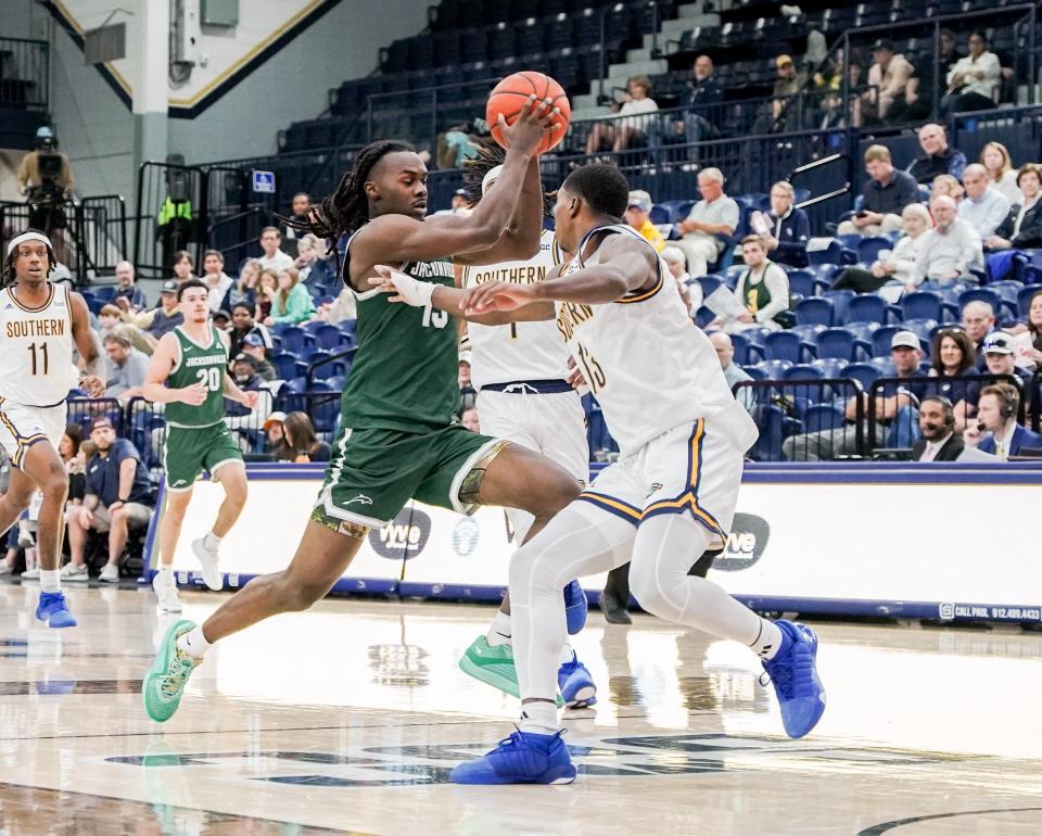 Jacksonville University guard Robert McCray (13) drives against a Georgia Southern player on Saturday. McCray scored JU's last 10 points in an 81-79 victory.