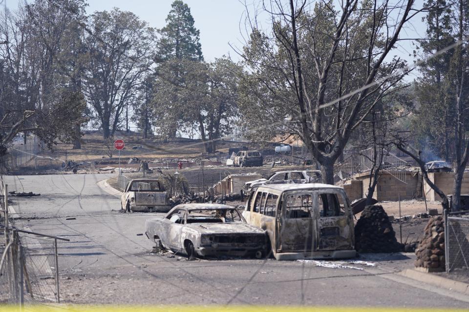 Burned out vehicles rest on a street in downtown Weed on Sept. 3 the day after the Mill Fire broke out in Weed and raced north toward the Northern California community of Lake Shastina near the Oregon border.