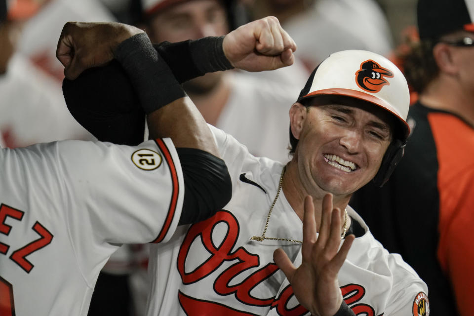 Baltimore Orioles' Austin Hays, right, is greeted in the dugout by Kelvin Gutierrez after hitting a two-run home run off New York Yankees relief pitcher Chad Green during the eighth inning of a baseball game, Wednesday, Sept. 15, 2021, in Baltimore. (AP Photo/Julio Cortez)