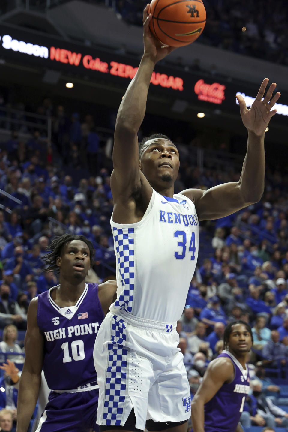 Kentucky's Oscar Tshiebwe (34) shoots near High Point's Emmanuel Izunabor (10) during the first half of an NCAA college basketball game in Lexington, Ky., Friday, Dec. 31, 2021. (AP Photo/James Crisp)