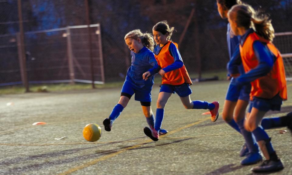 <span>The report found that ‘playing football is meaningful, with girls who play gaining life skills that go beyond participation in sport, directly contributing to personal growth and identity formation’.</span><span>Photograph: Caia Image/Getty Images</span>