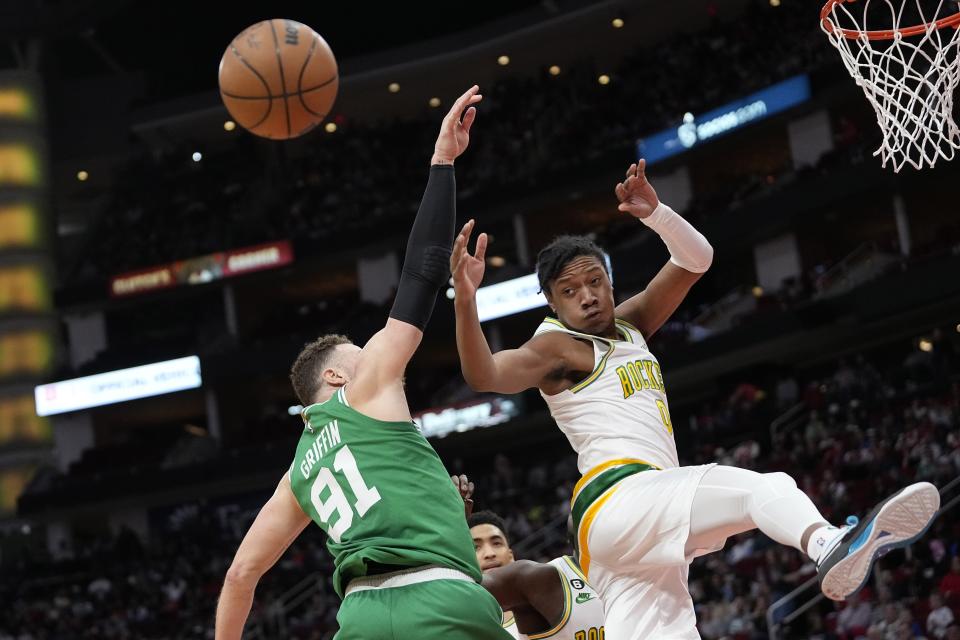 Boston Celtics' Blake Griffin (91) and Houston Rockets' TyTy Washington Jr. (0) reach for a rebound during the first half of an NBA basketball game Monday, March 13, 2023, in Houston. (AP Photo/David J. Phillip)