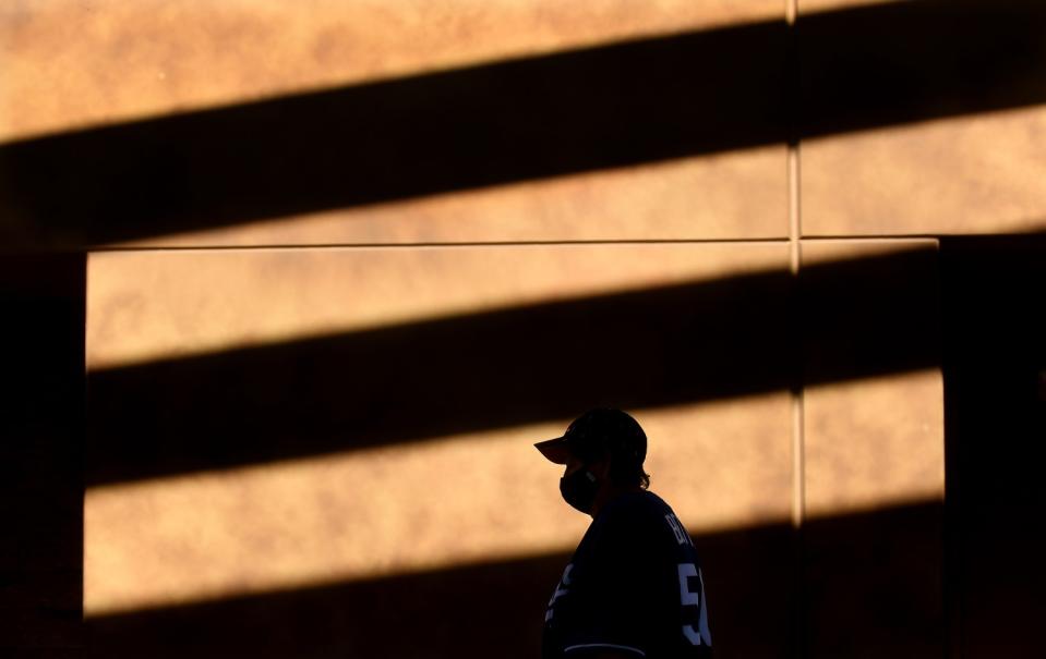 A Dodgers fan walks to a concession stand before a game