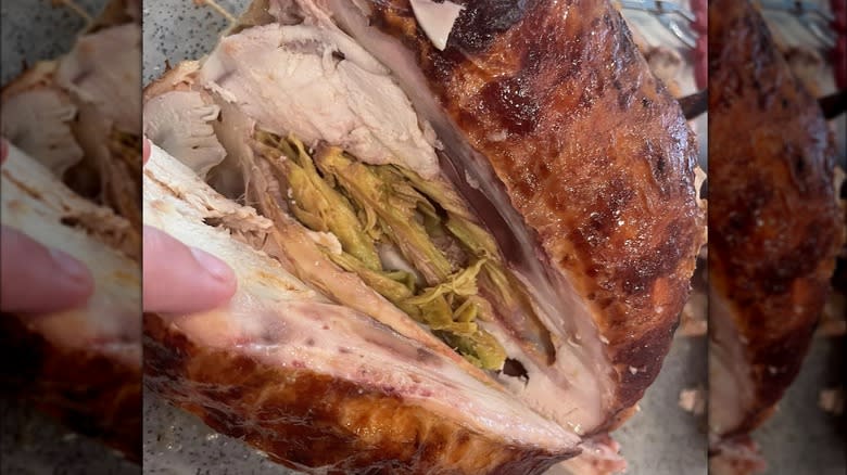 Closeup of green meat in a cooked rotisserie chicken