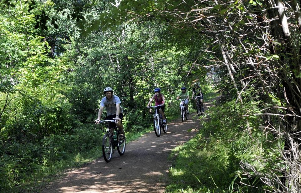 A family rides the Brickyard Trail portion of the Green Circle Trail south of Zenoff Park in Stevens Point.