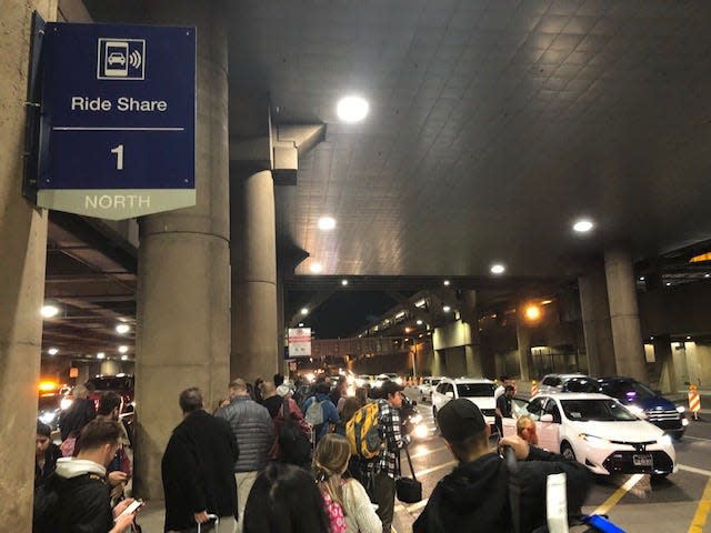 Crowds outside the 1 North Ride Share pickup location at Sky Harbor Airport on Nov. 30, 2019.