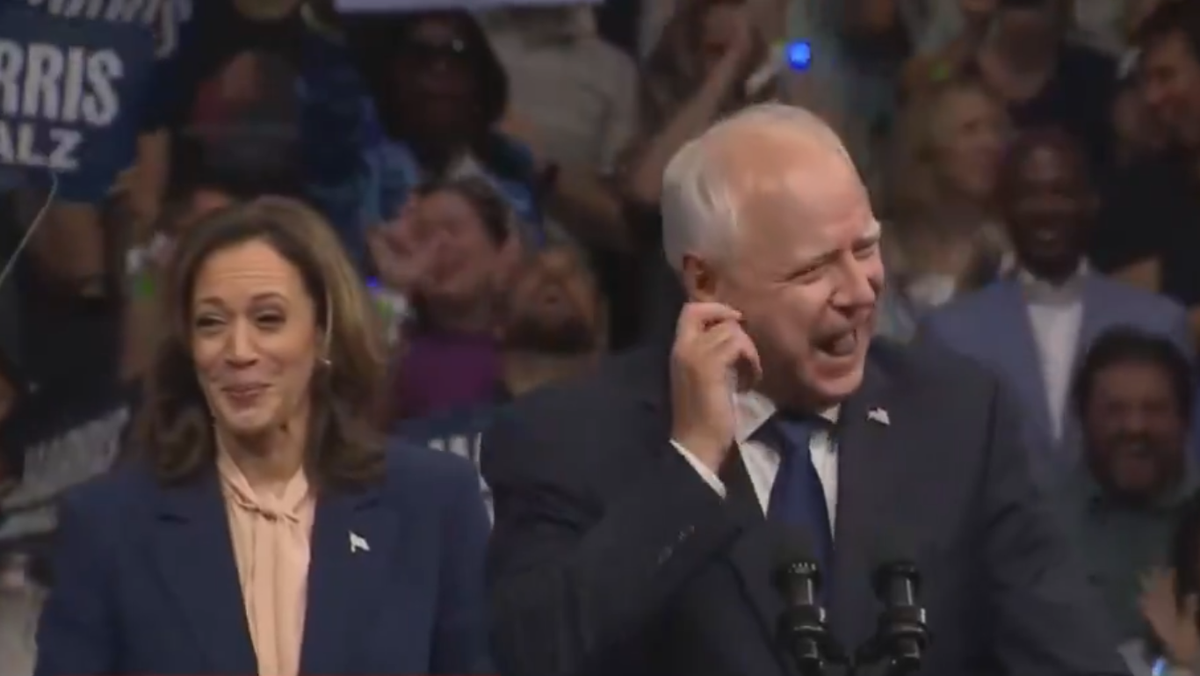 Harris appeared to stifle her laughter after her newly announced running mate Tim Walz made reference to a viral, couch-related scandal involving JD Vance (Screengrab/ CNN)