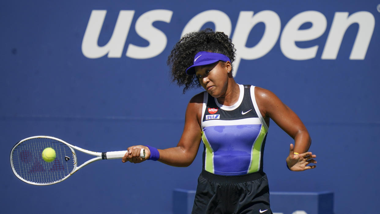 Naomi Osaka, of Japan, returns a shot to Marta Kostyuk, of the Ukraine, during the third round of the US Open tennis championships, Friday, Sept. 4, 2020, in New York. (AP Photo/Seth Wenig)