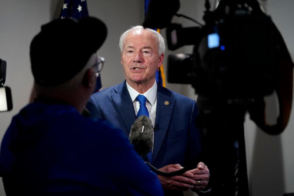 Republican presidential candidate former Arkansas Gov. Asa Hutchinson speaks to reporters after meet and greet at the VFW Post 9127, Thursday, April 13, 2023, in Des Moines, Iowa.